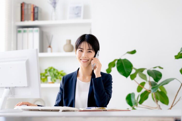 笑顔で電話対応する女性