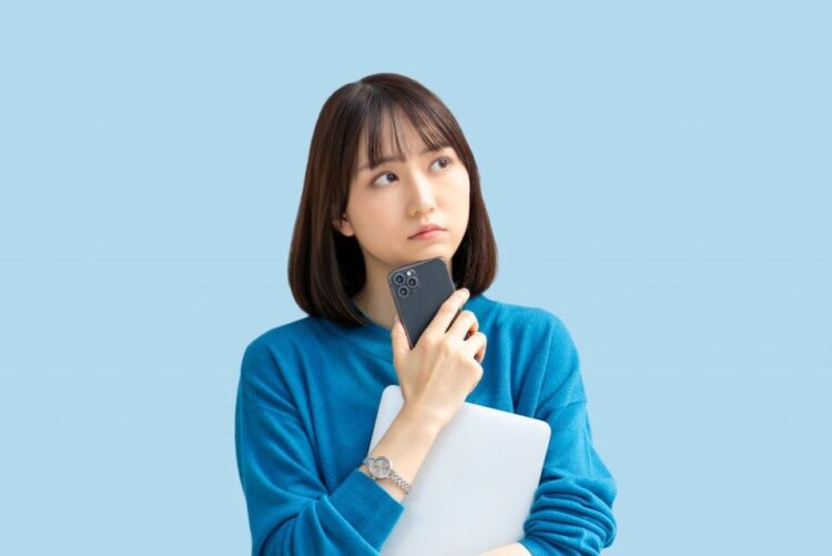 電話の対応を思案する女性